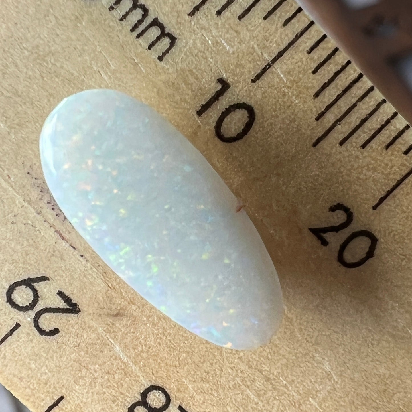Beautiful array of colour in this solid white opal from Coober Pedy. A nice cut and ready to set.