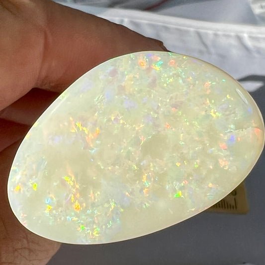 Large Coober Pedy solid white opal. Lots of colours and beautifully polished. Would make a great pendant. Double sided.