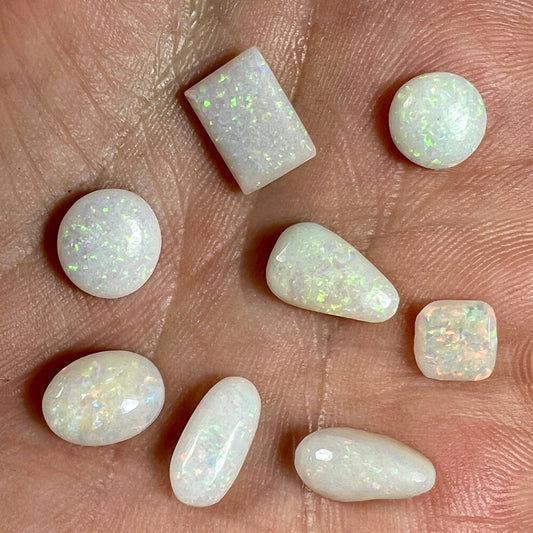 Solid white opal bundle comprising of 8 beautiful Coober Pedy ring stones in various shapes. Mainly pin fire. Ideal for jewellery makers.