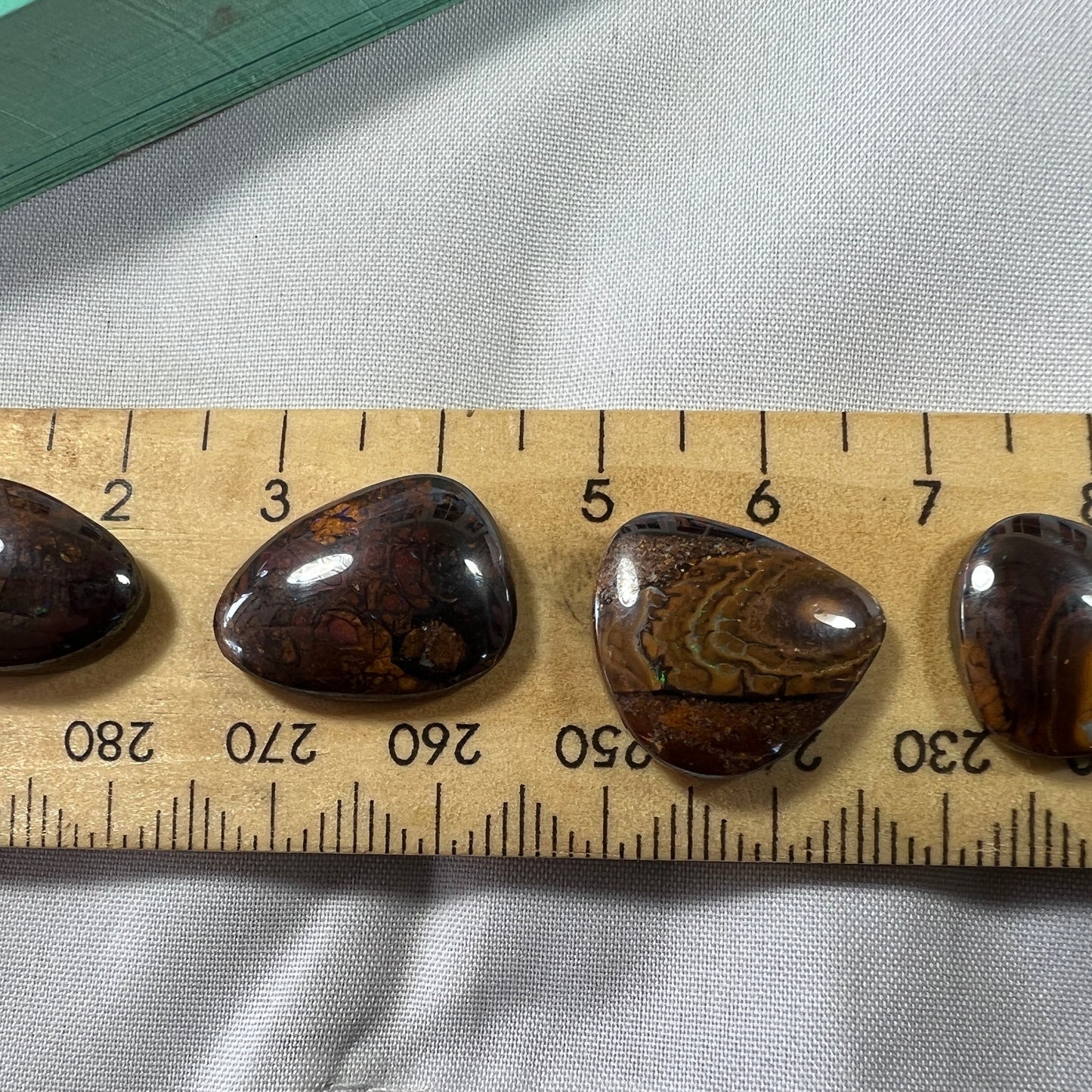 Four lovely pieces of boulder opal from Winton. Nice dome and polish showing great colours.