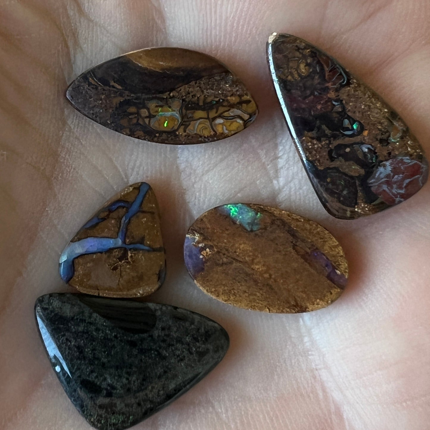4 x Winton opals and 1 x Andamooka Matrix opal. Beautiful specimens showing lovely colours. Polished and ready to set.