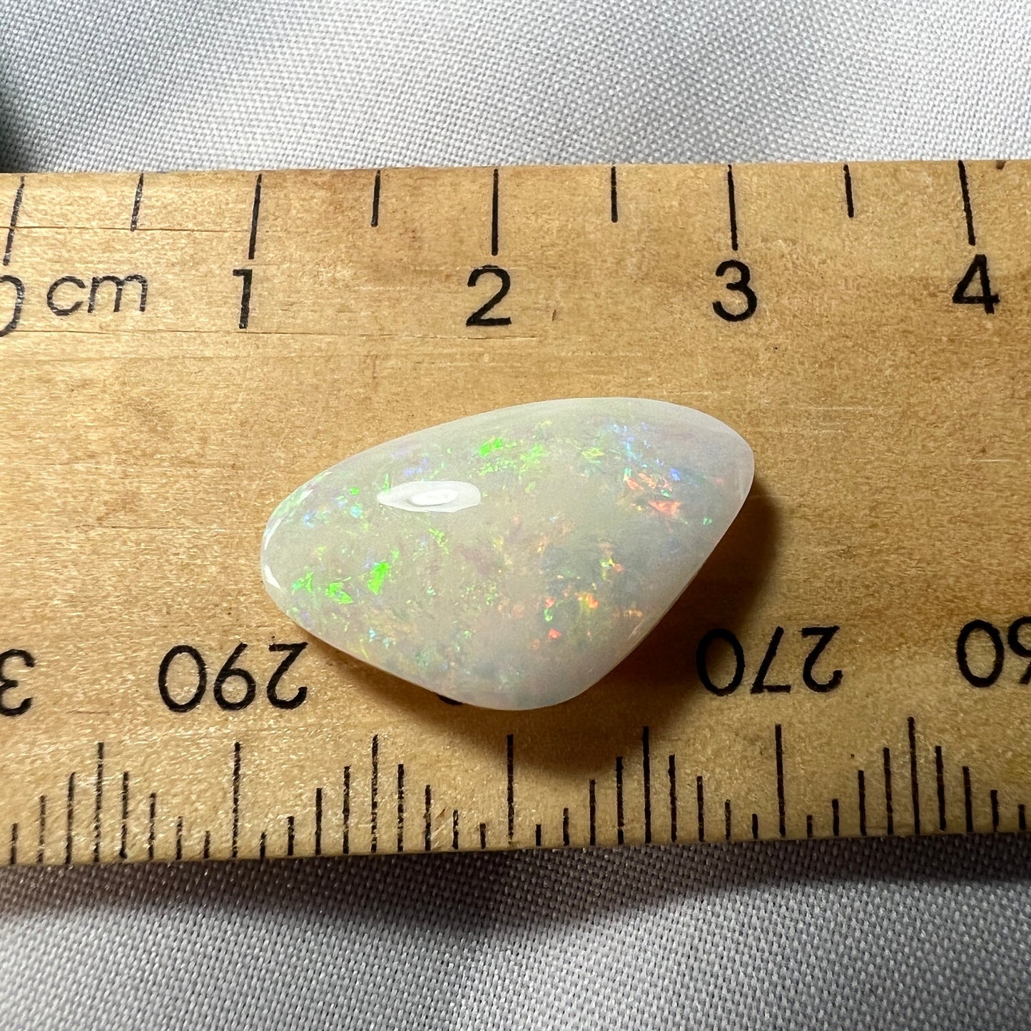 Nice piece of Coober Pedy white opal. Lots of colours showing and a great polish.