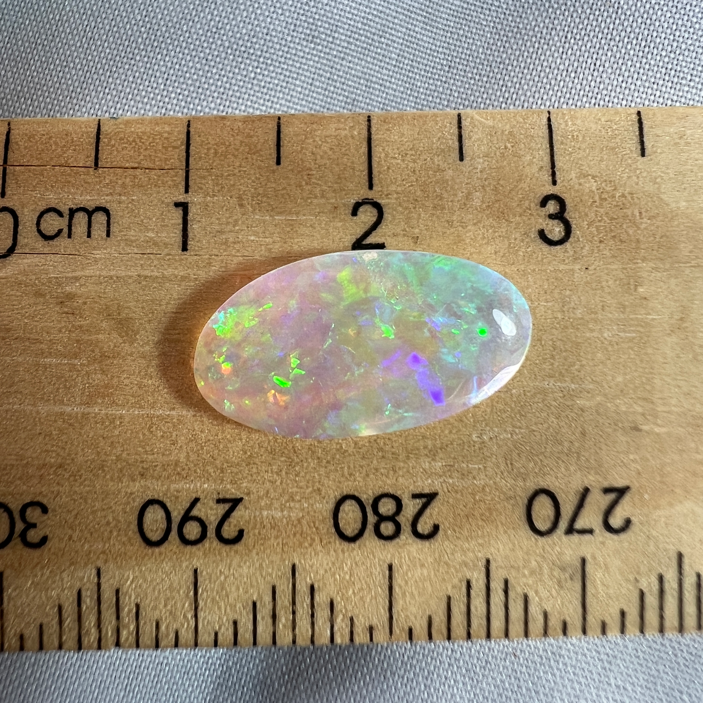 Perfect Lightning Ridge crystal opal displaying magnificent colours. Both sides are polished. Cut by Bill Johnston.