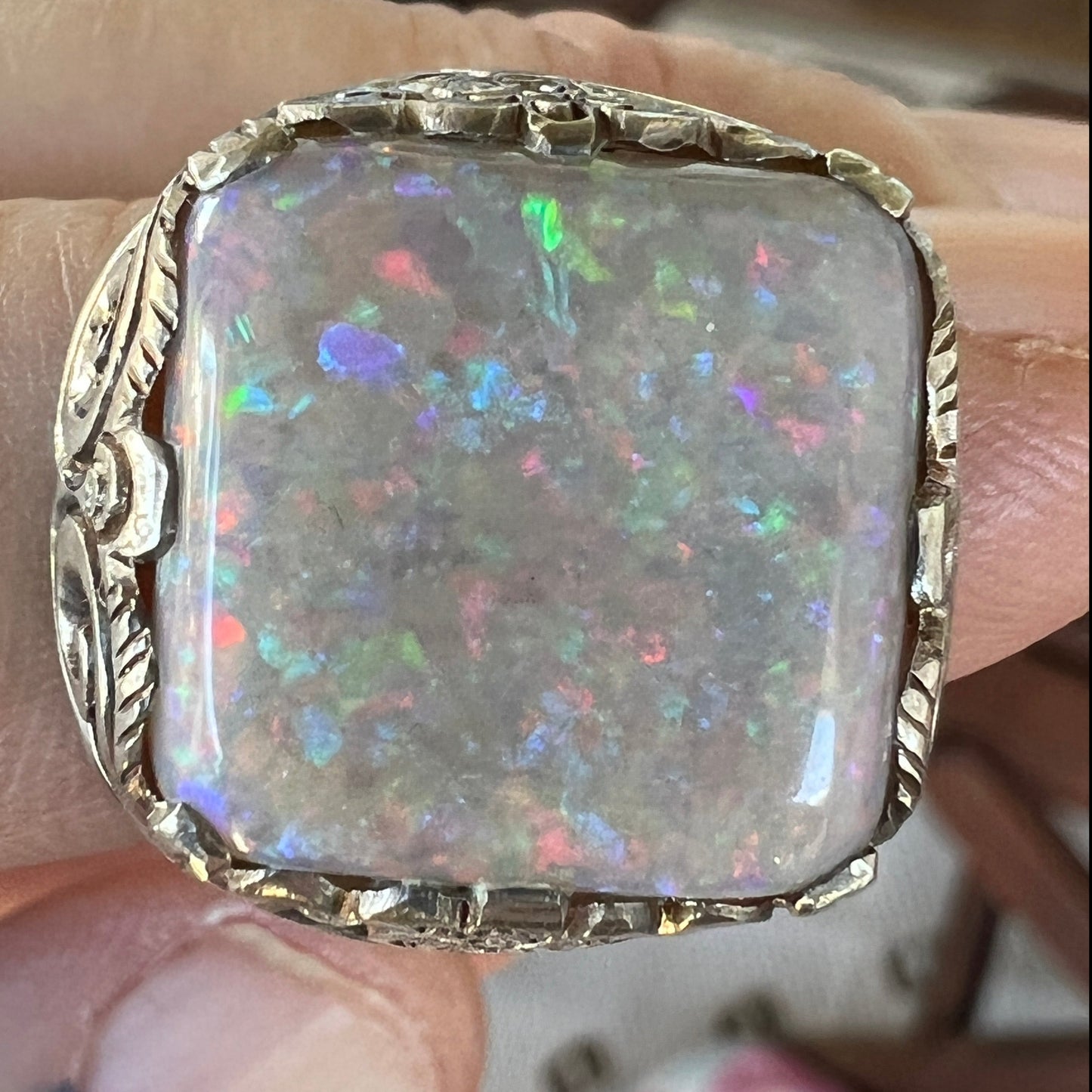 Magnificent handmade silver ring featuring a beautiful cushion cut 10ct Coober Pedy opal, displaying a wonderful full array of pinfire colours. One of a kind.