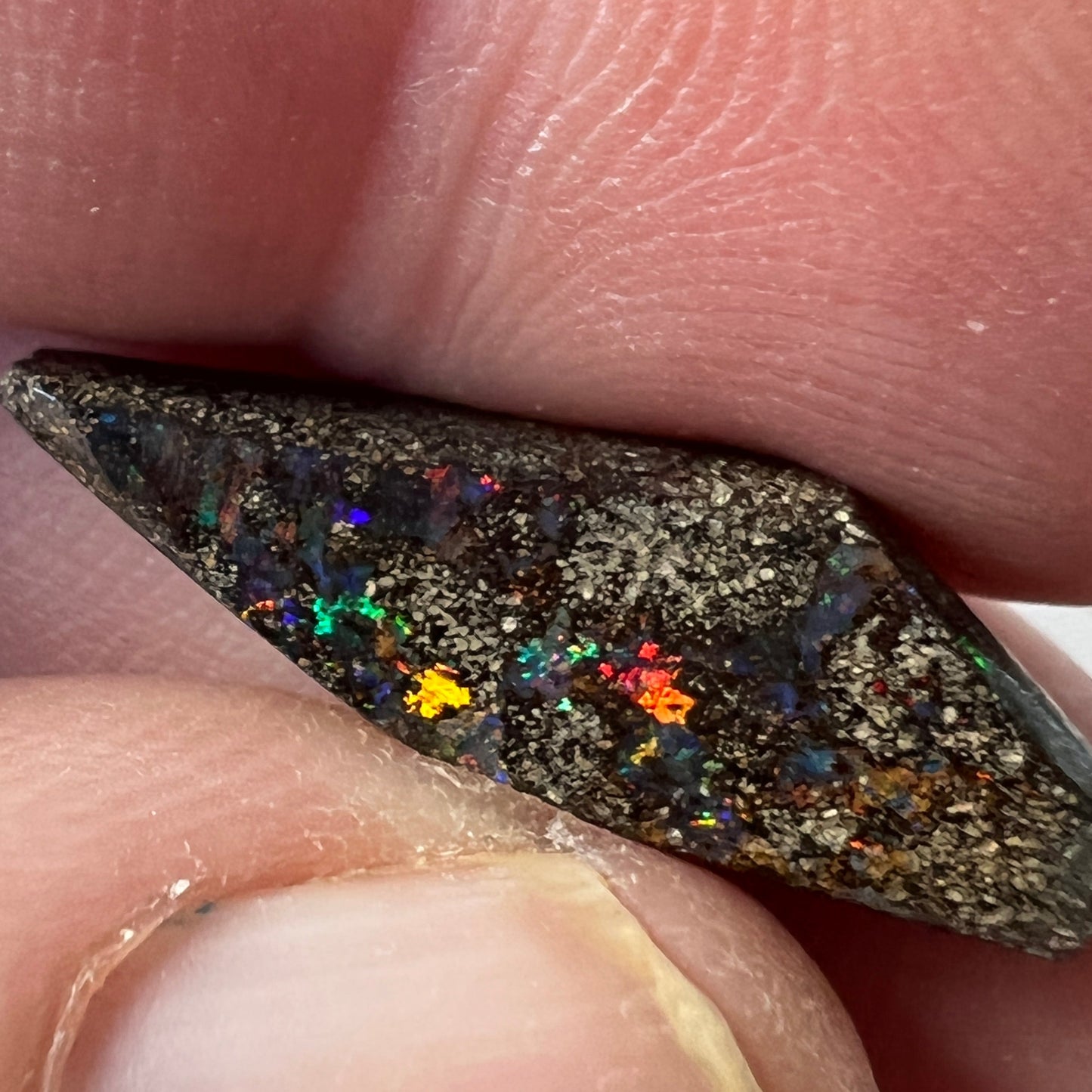Great piece of Winton boulder opal showing nice colours including reds.