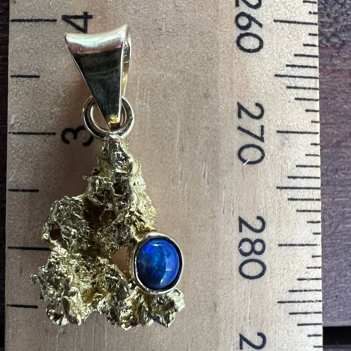 Pure solid gold nugget pendant from Western Australia, with an 18ct gold bale. Set with a beautiful solid black opal from Lightning Ridge.