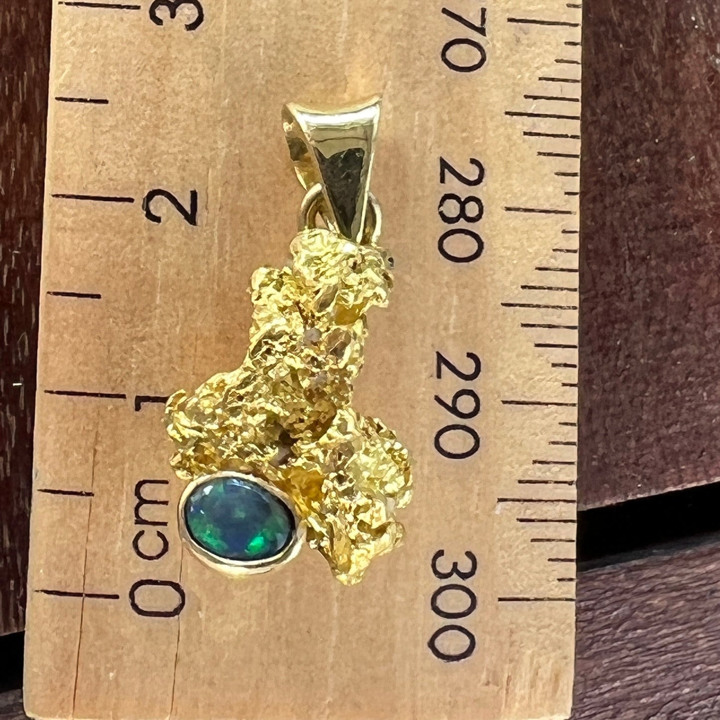 Pure gold nugget pendant from Western Australia, perfectly set and balanced with 18ct bale. Set with a beautiful Lightning Ridge solid black opal.