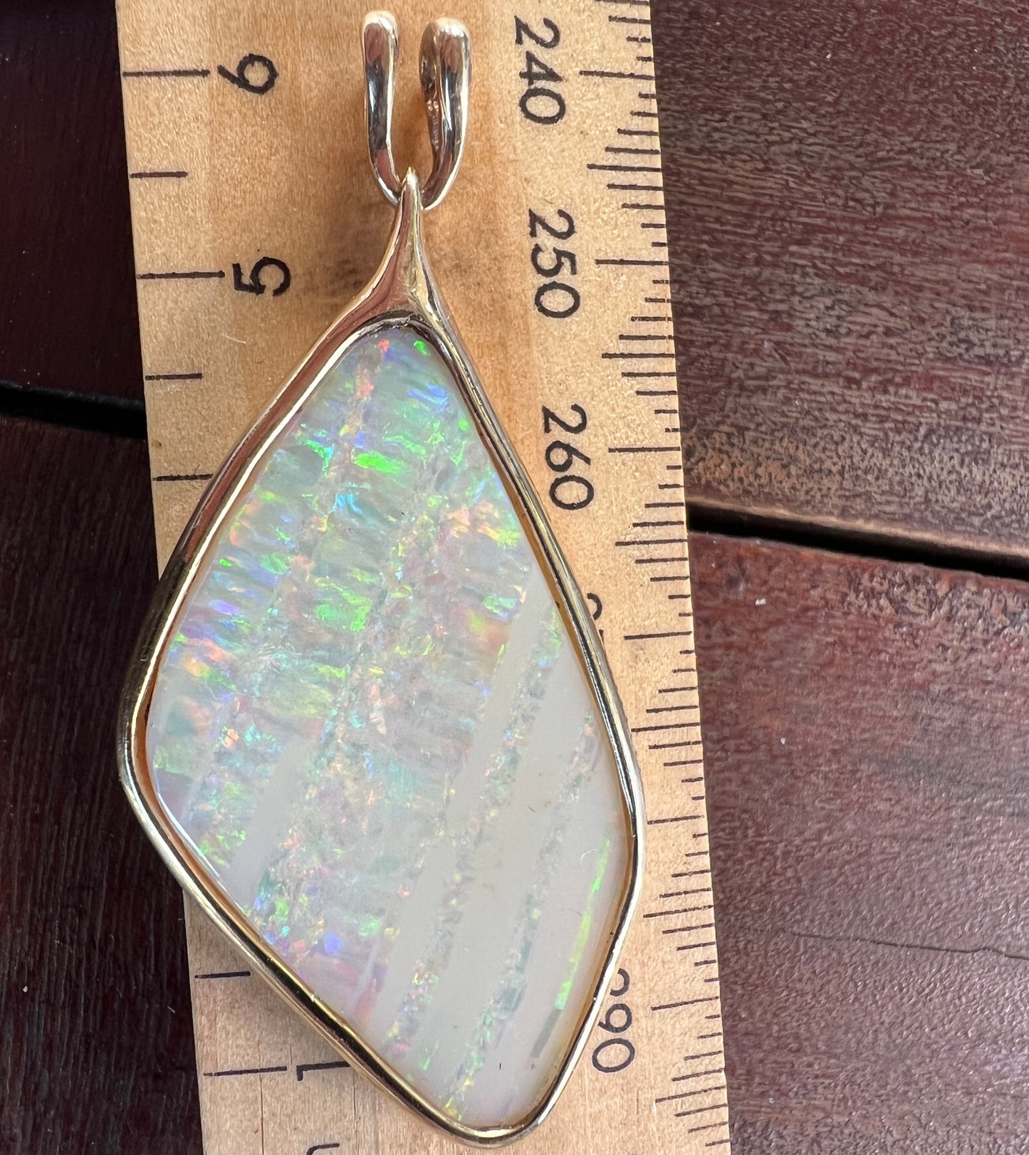 Beautiful solid vertical Mulga from the mine of Craig Haxton in Lightning Ridge. Very simple solid gold setting which enhances the beautiful colours shown in this statement piece.