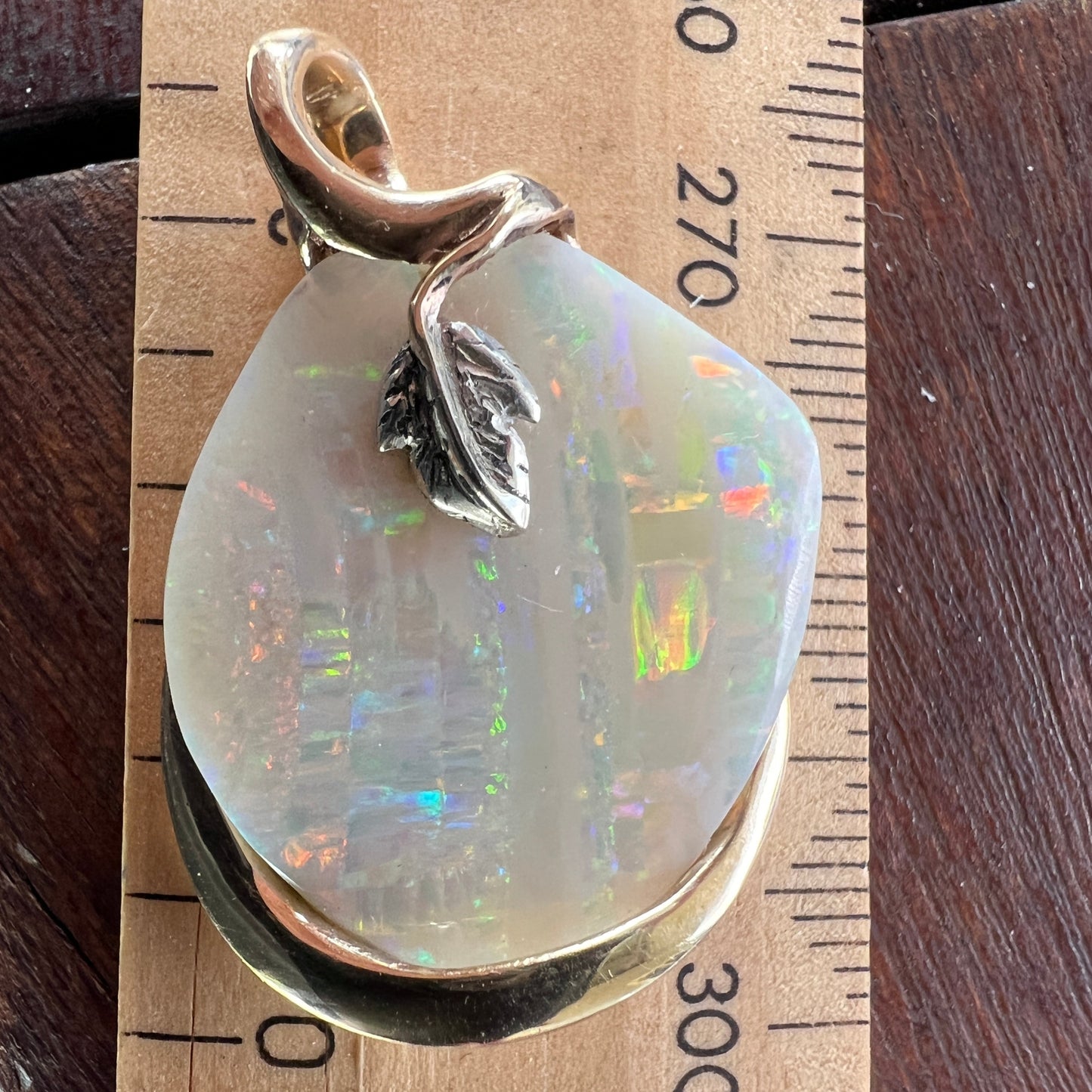 Beautiful solid vertical Mulga opal from the mines of Craig Haxton in Lightning Ridge. Gorgeous yellow gold and white gold setting with a platinum leaf, showcasing all of the Autumnal colours. Another Sally Fisher masterpiece.