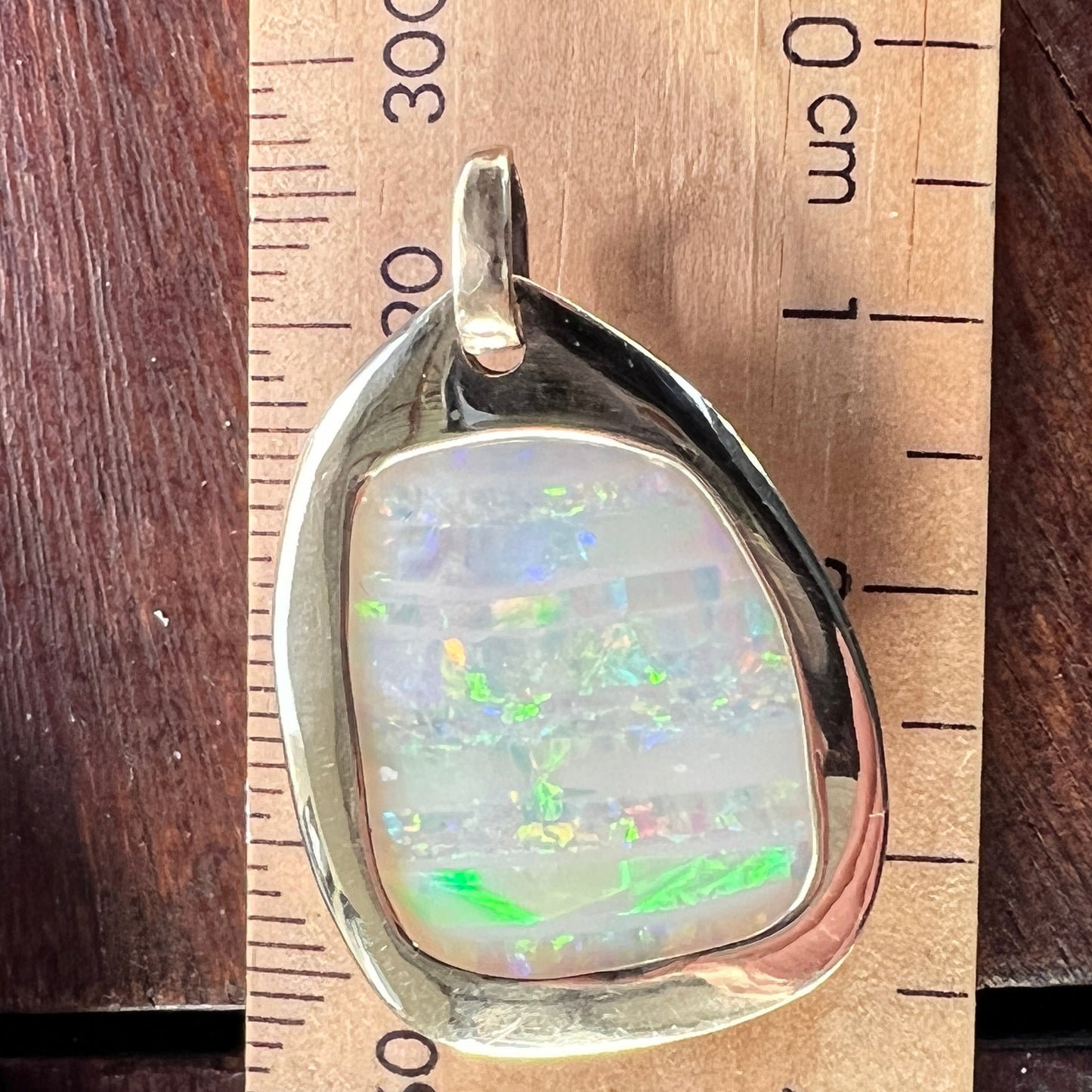Beautiful solid vertical Mulga from the mine of Craig Haxton in Lightning Ridge. Set in a very simple but classic gold pendant, hand crafted by Sally Fisher.