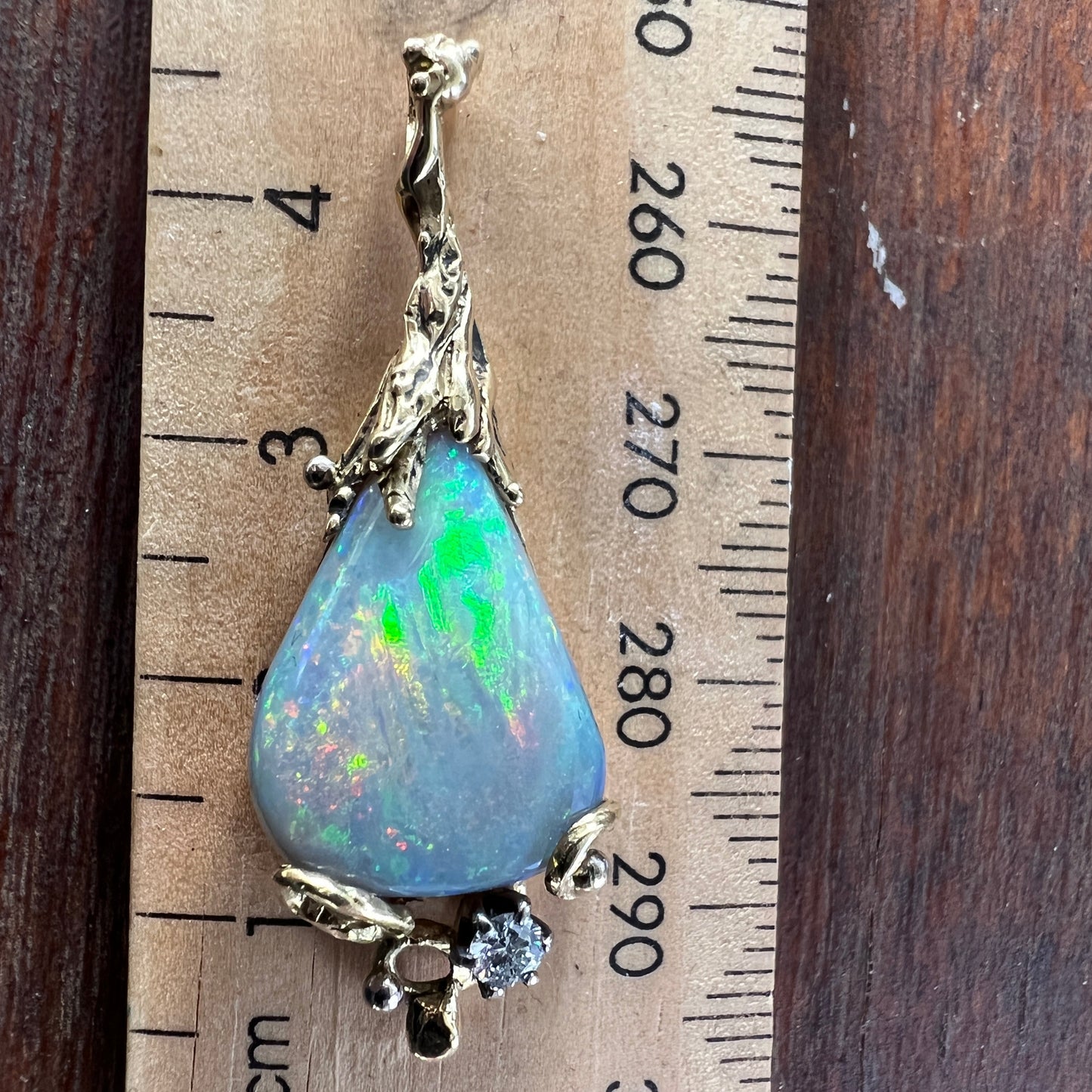 Stunning pendant hand made by Sally Fisher. Beautiful 8.5ct Lightning Ridge black opal mined 25-30 metres below what is now the 'Black Opal Motel'. Moulded 18ct gold finished off with a brilliant cut diamond. A masterpiece.