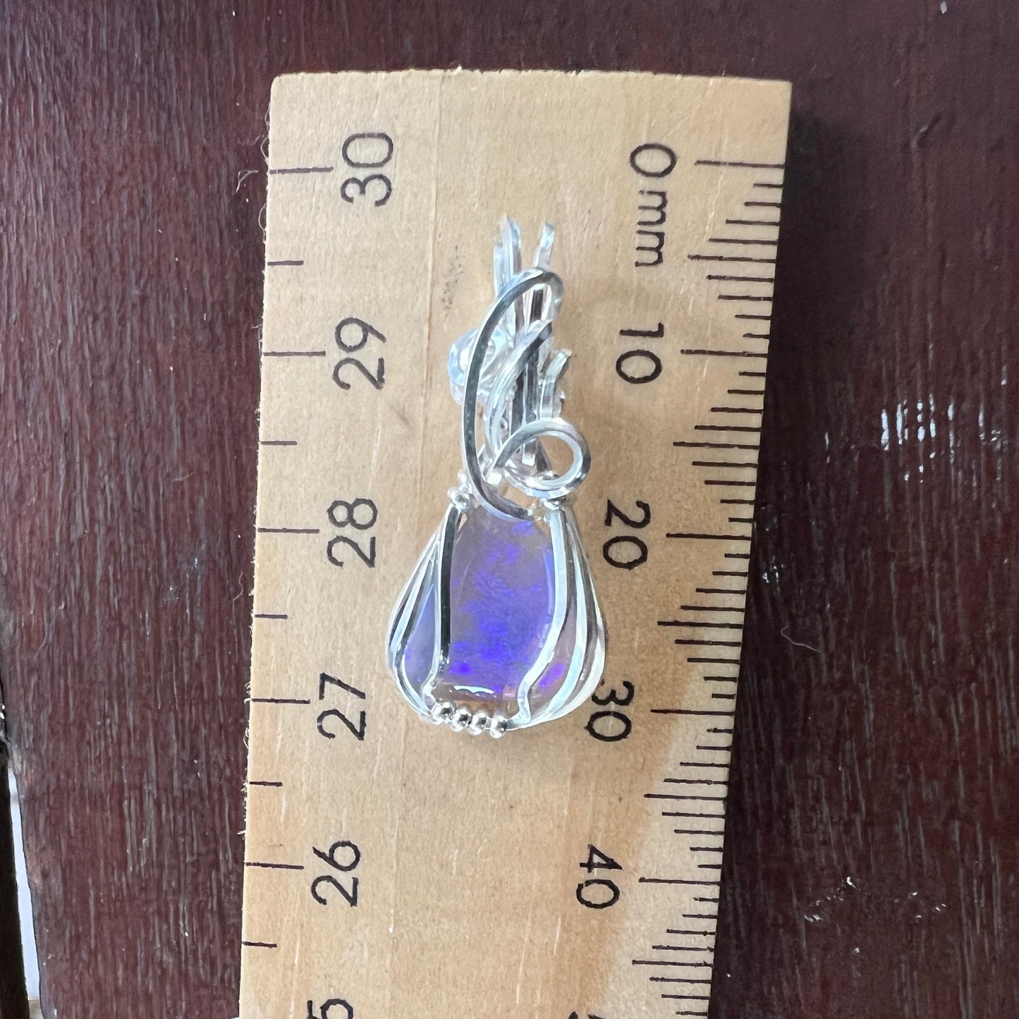 Beautifully cut Lightning Ridge Jelly Crystal opal. Cut and polished by Bill Johnson. Expertly set in a unique wire silver wrap. An awesome hand made gift.