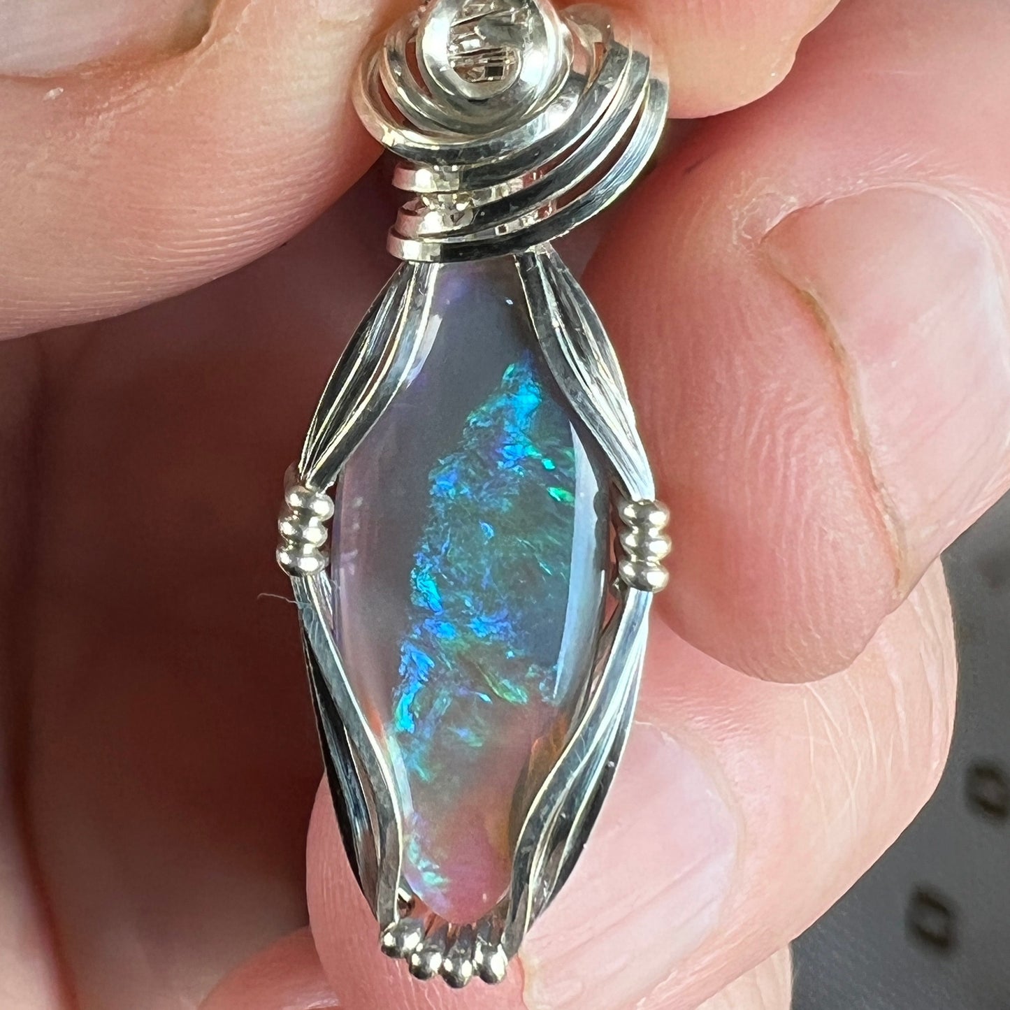 Beautifully cut Lightning Ridge Jelly Crystal opal. Cut and polished by Bill Johnson. Expertly set in a unique silver wire wrap. An awesome hand made gift.