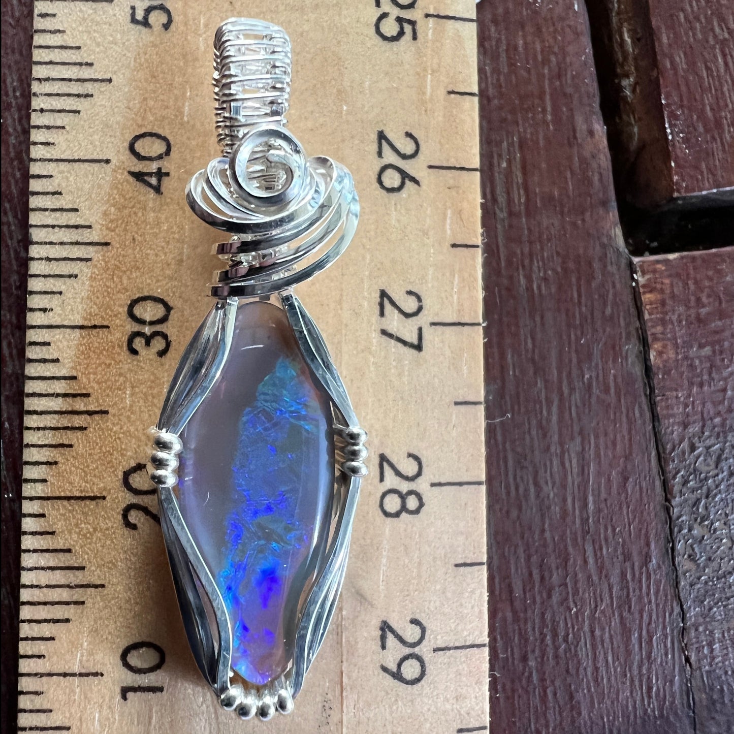 Beautifully cut Lightning Ridge Jelly Crystal opal. Cut and polished by Bill Johnson. Expertly set in a unique silver wire wrap. An awesome hand made gift.