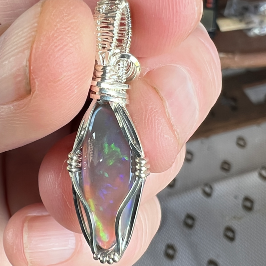 Beautifully cut Lightning Ridge Jelly Crystal opal. Cut and polished by Bill Johnson. Expertly set in a unique silver wire wrap. An awesome hand made gift.