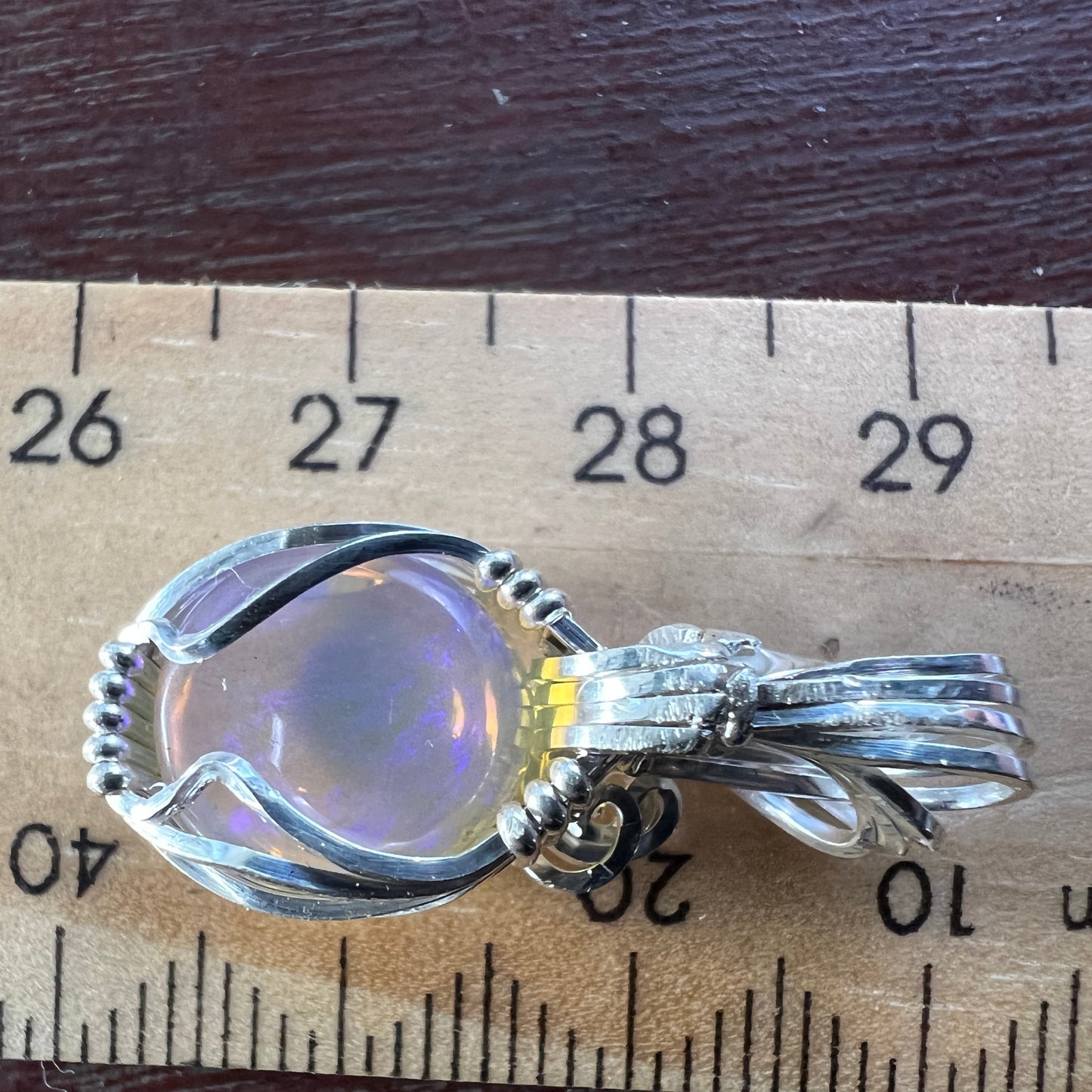 Beautifully cut Lightning Ridge Jelly Crystal opal. Cut and polished by Bill Johnson. Expertly set in a unique silver wire wrap. An awesome hand made gift.