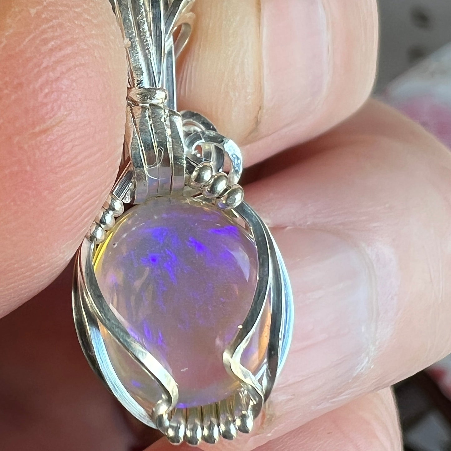 Beautifully cut Lightning Ridge Jelly Crystal opal. Cut and polished by Bill Johnson. Expertly set in a unique silver wire wrap. An awesome hand made gift.