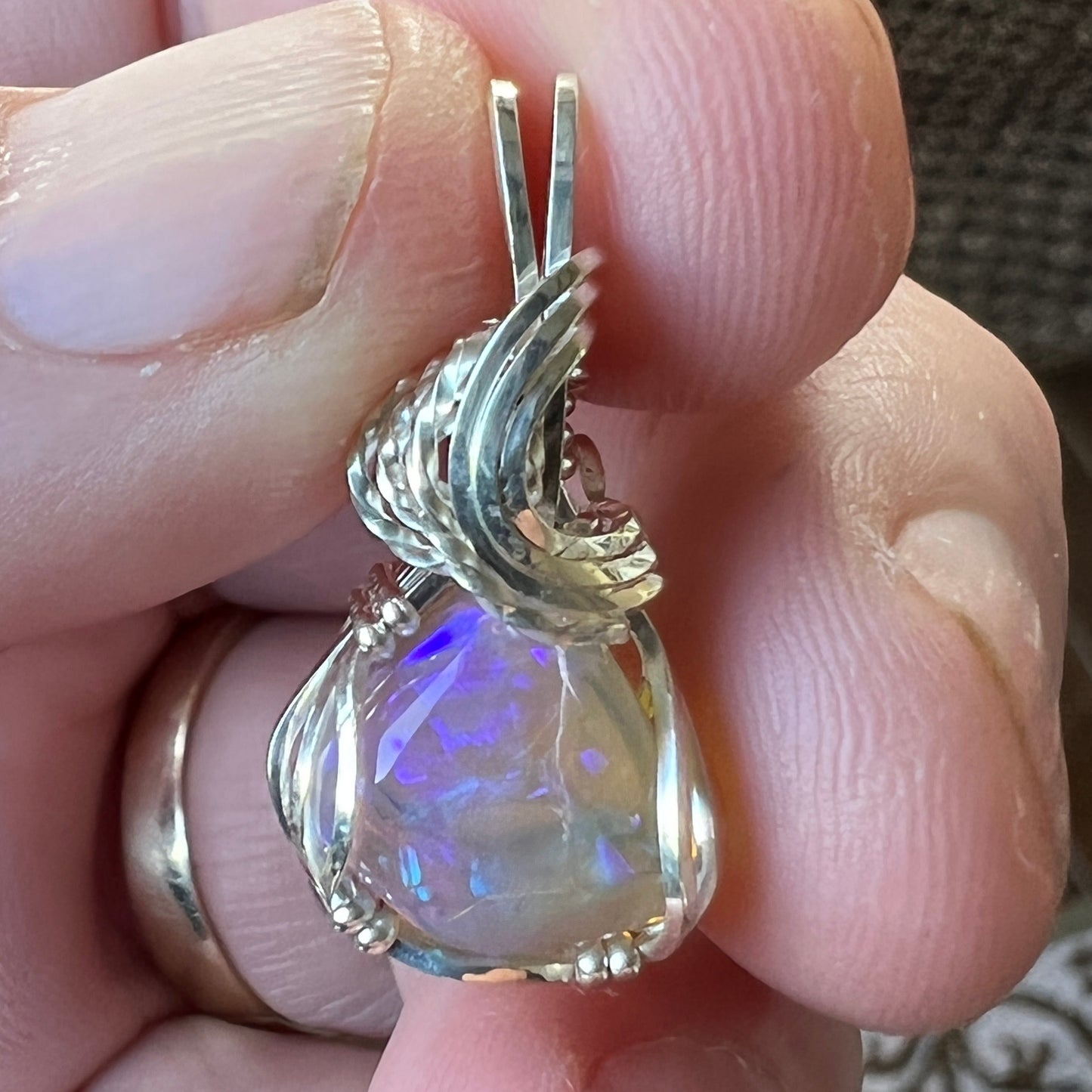 Beautifully cut Lightning Ridge Jelly Crystal opal. Cut and polished by Bill Johnson. Expertly set in a unique silver wire wrap. An awesome hand made gift.