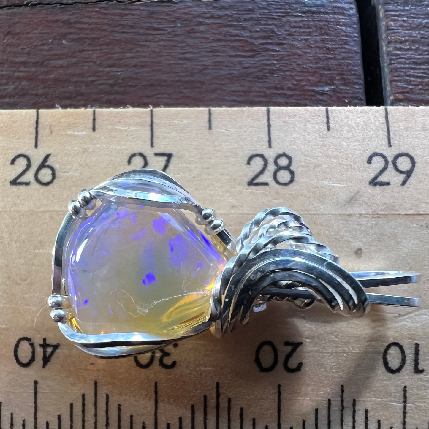 Beautifully cut Lightning Ridge Jelly Crystal opal. Cut and polished by Bill Johnson. Expertly set in a unique silver wire wrap. An awesome hand made gift.