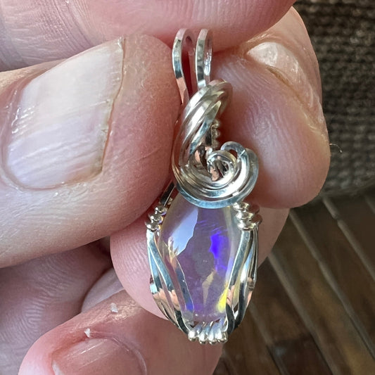 Beautifully cut Lightning Ridge Jelly Crystal opal. Cut and polished by Bill Johnson. Expertly set in a unique silver wire wrap. An awesome hand made gift.
