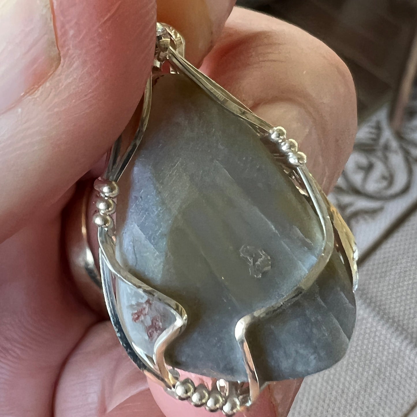 Unique Coober Pedy grey base opal on a silver hand made wire pendant. Nice colours.