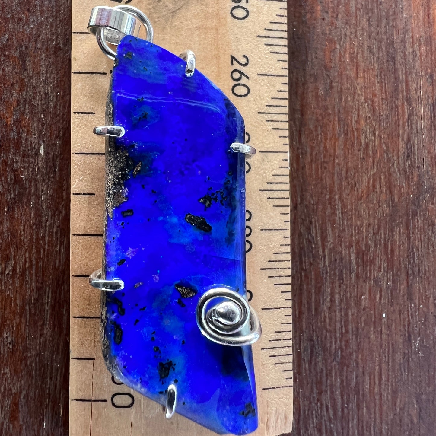 Lovely blue Winton Boulder opal, nicely wire-wrapped in silver. A great piece.