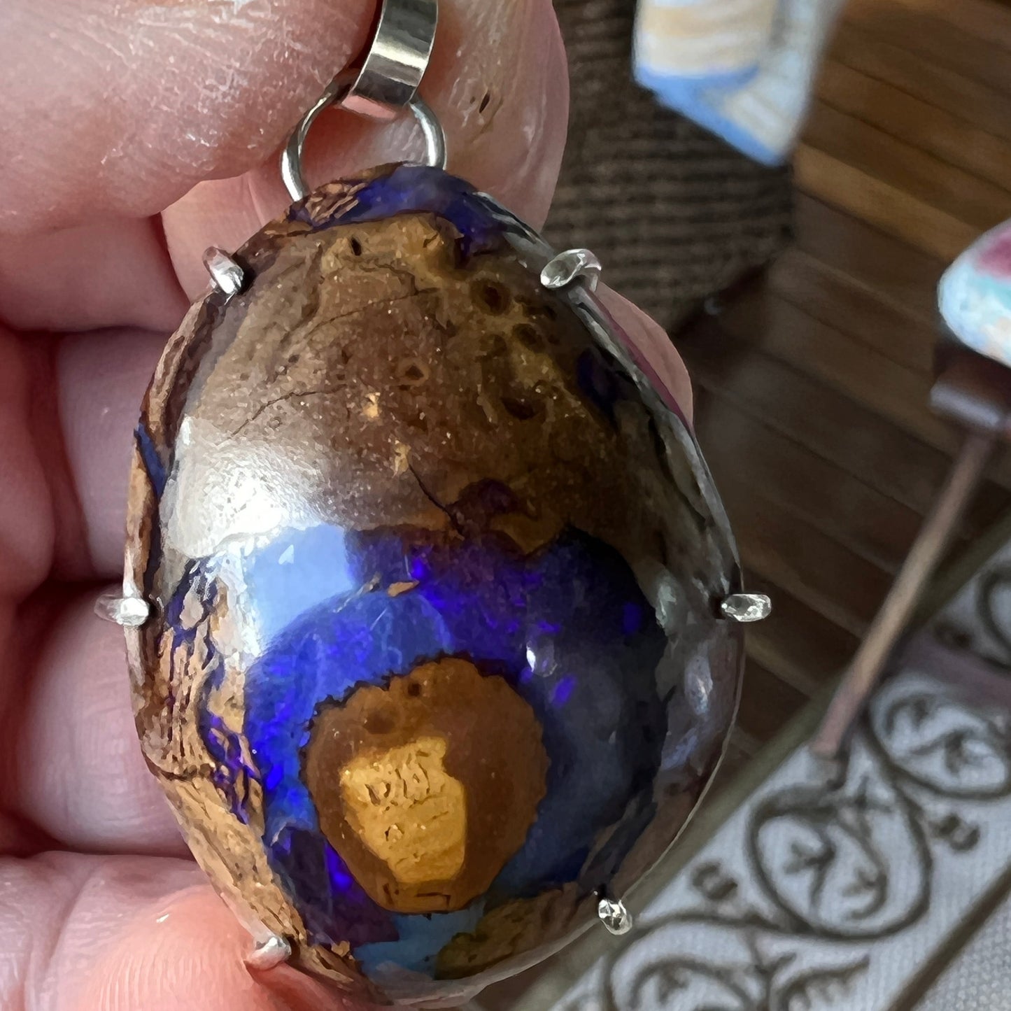 Beautiful example of Winton Boulder opal with an expert polish. Custom made silver mount. A lovely piece.