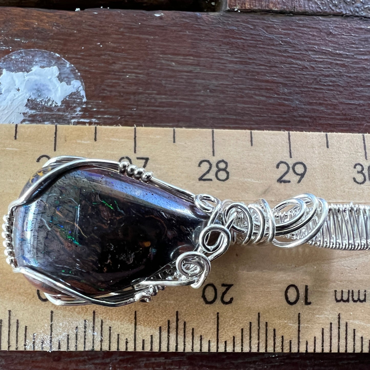 Awesome silver wire wrapped Winton Boulder opal pendant. A great statement piece displaying lovely colours.