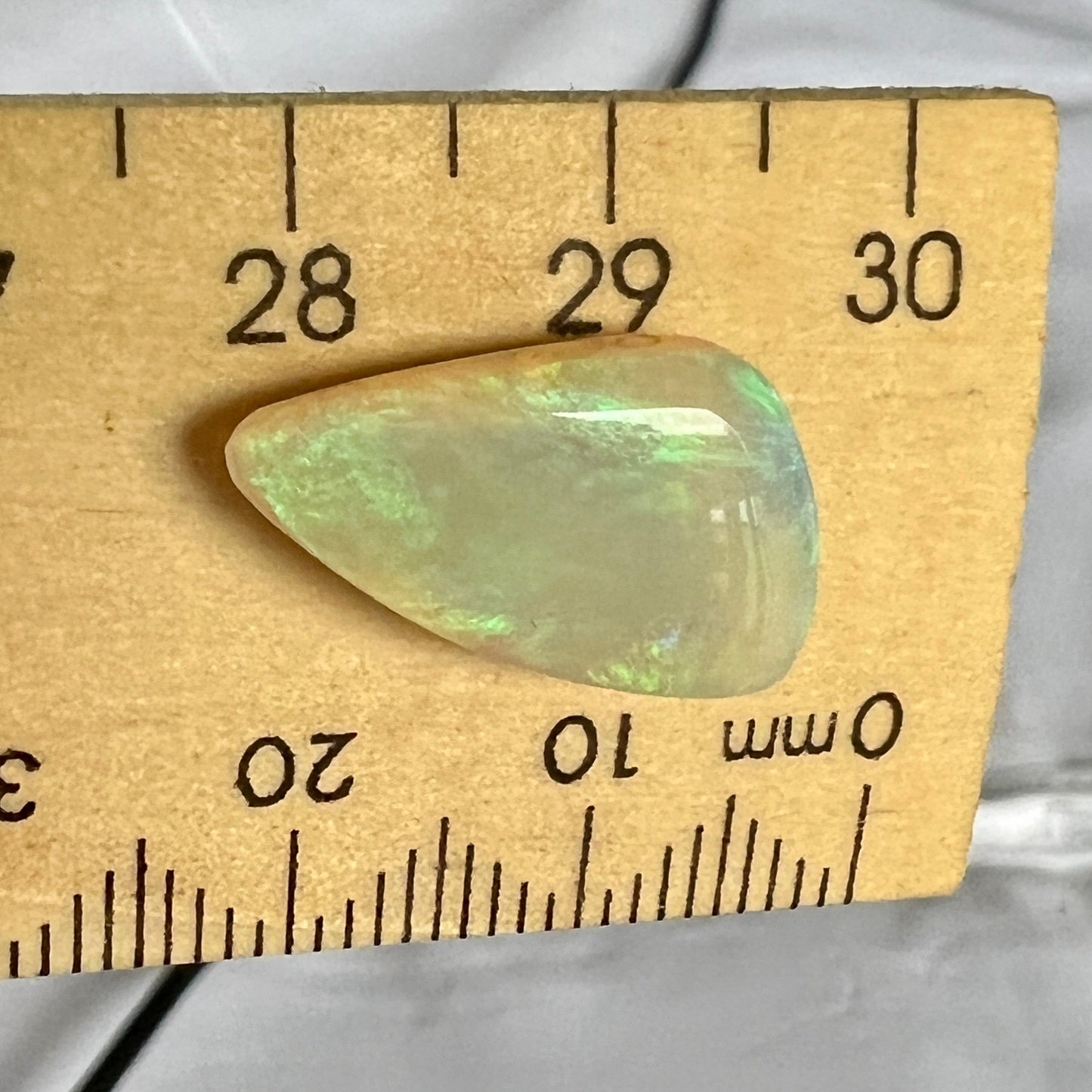 A great example of greens on grey. This Lightning Ridge solid Australian opal is polished to perfection.