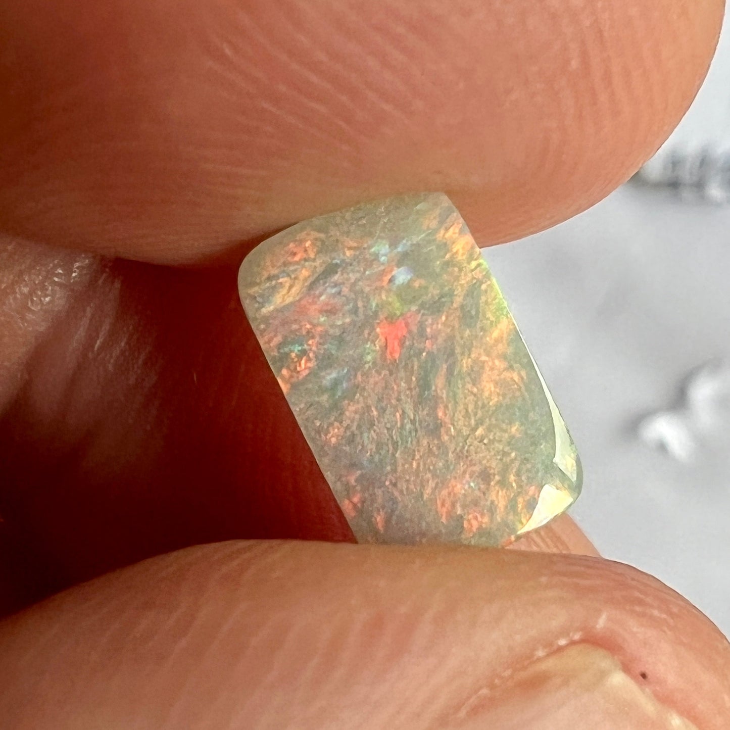 Semi-black opal from Lightning Ridge. A square cut beauty. Great pattern that shows off plenty of reds.
