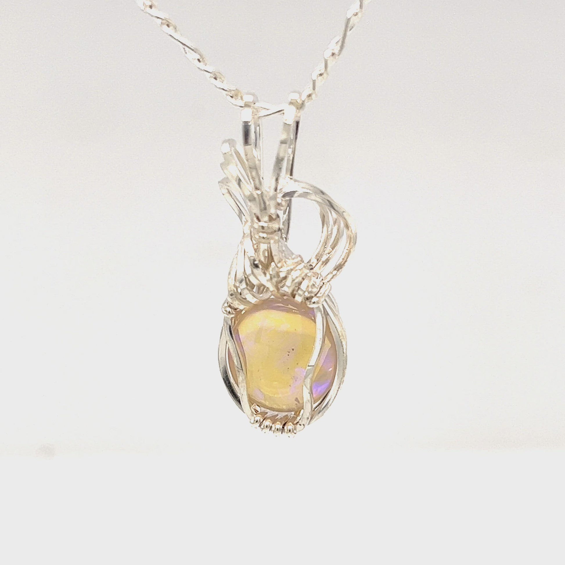 Beautifully cut Lightning Ridge Jelly Crystal opal. Cut and polished by Bill Johnson. Expertly set in a unique silver wire wrap. An awesome hand made gift.