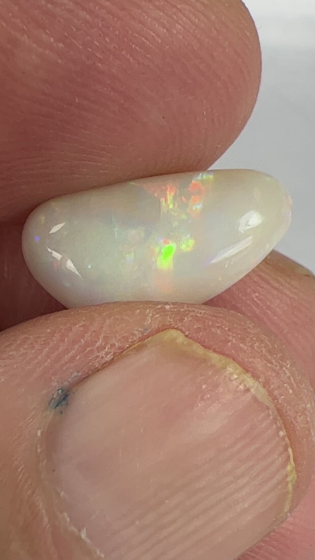 Nice solid white opal from Coober Pedy, displaying rolling flash colours. 