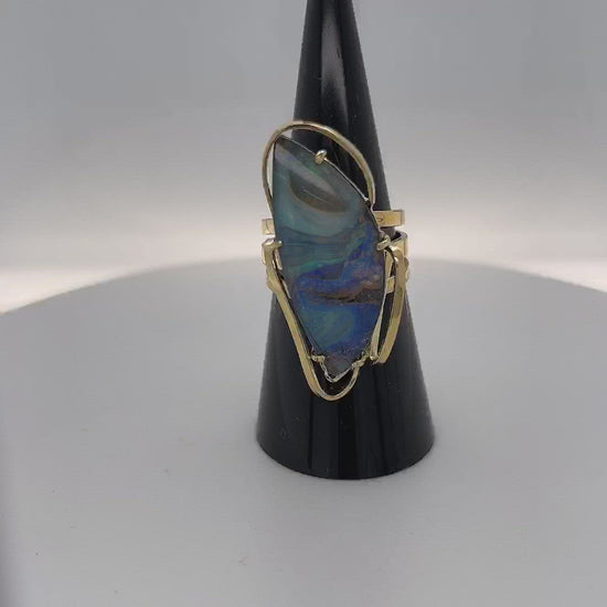 A beautiful statement ring custom made with rare Queensland Boulder opal. The stone has a perfect polish and is set in a wonderful 14ct gold triple ring.