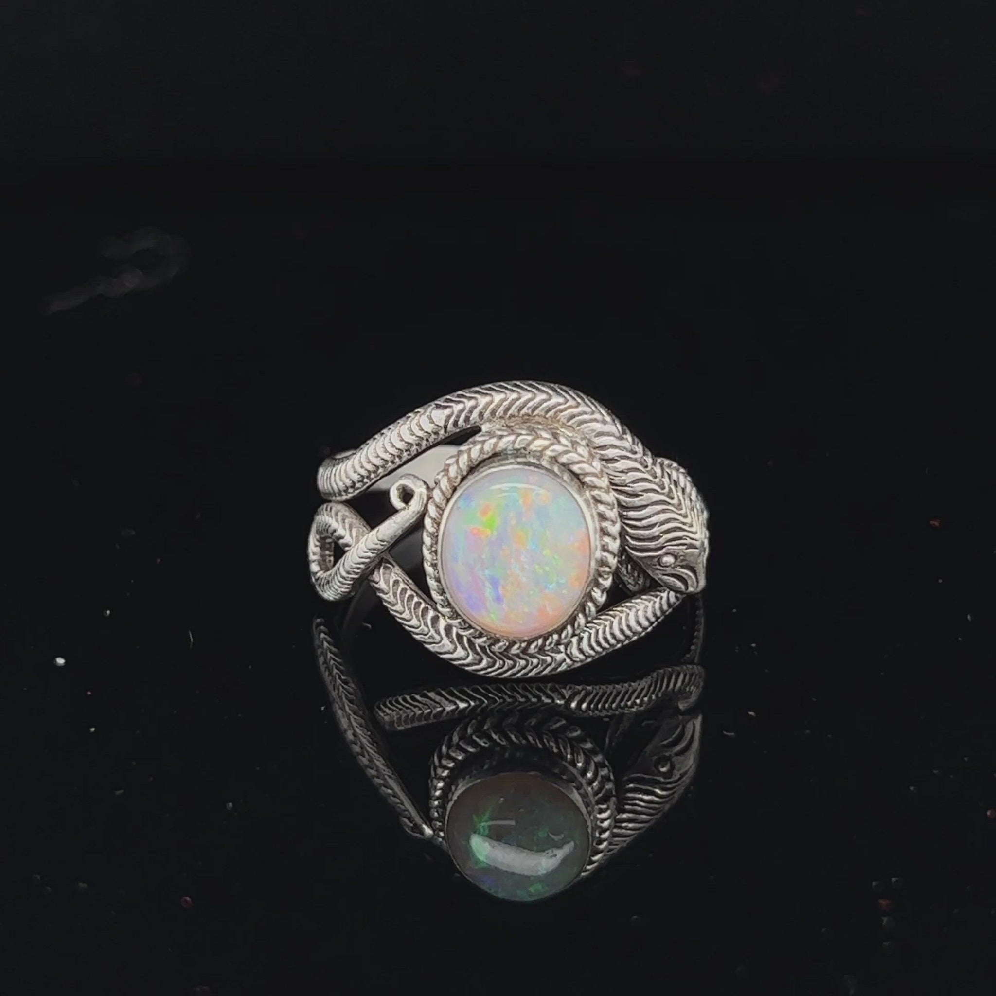 Beautifully handcrafted snake skin ring with a fantastic round cut Coober Pedy opal showing flashes of all colours.