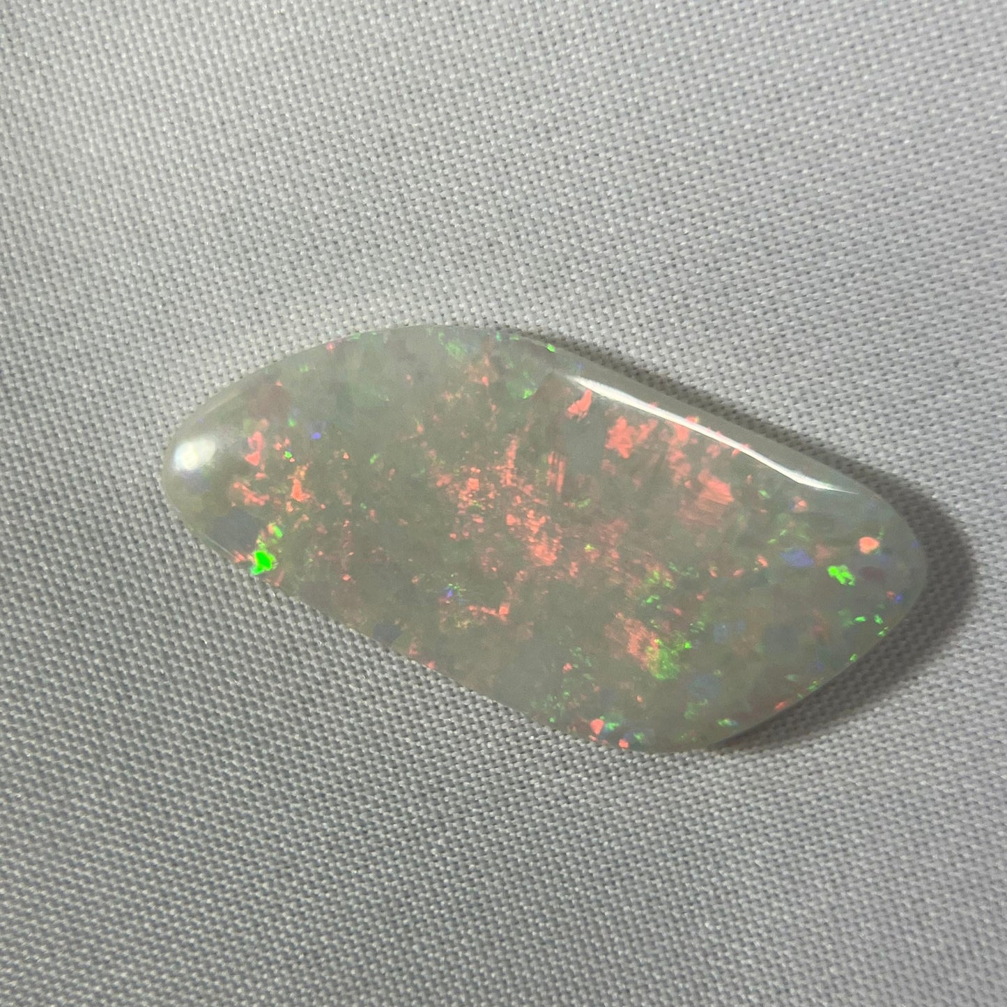 Lightning Ridge solid opal. Well shaped stone displaying stunning colours from all angles including plenty of reds, orange and greens.