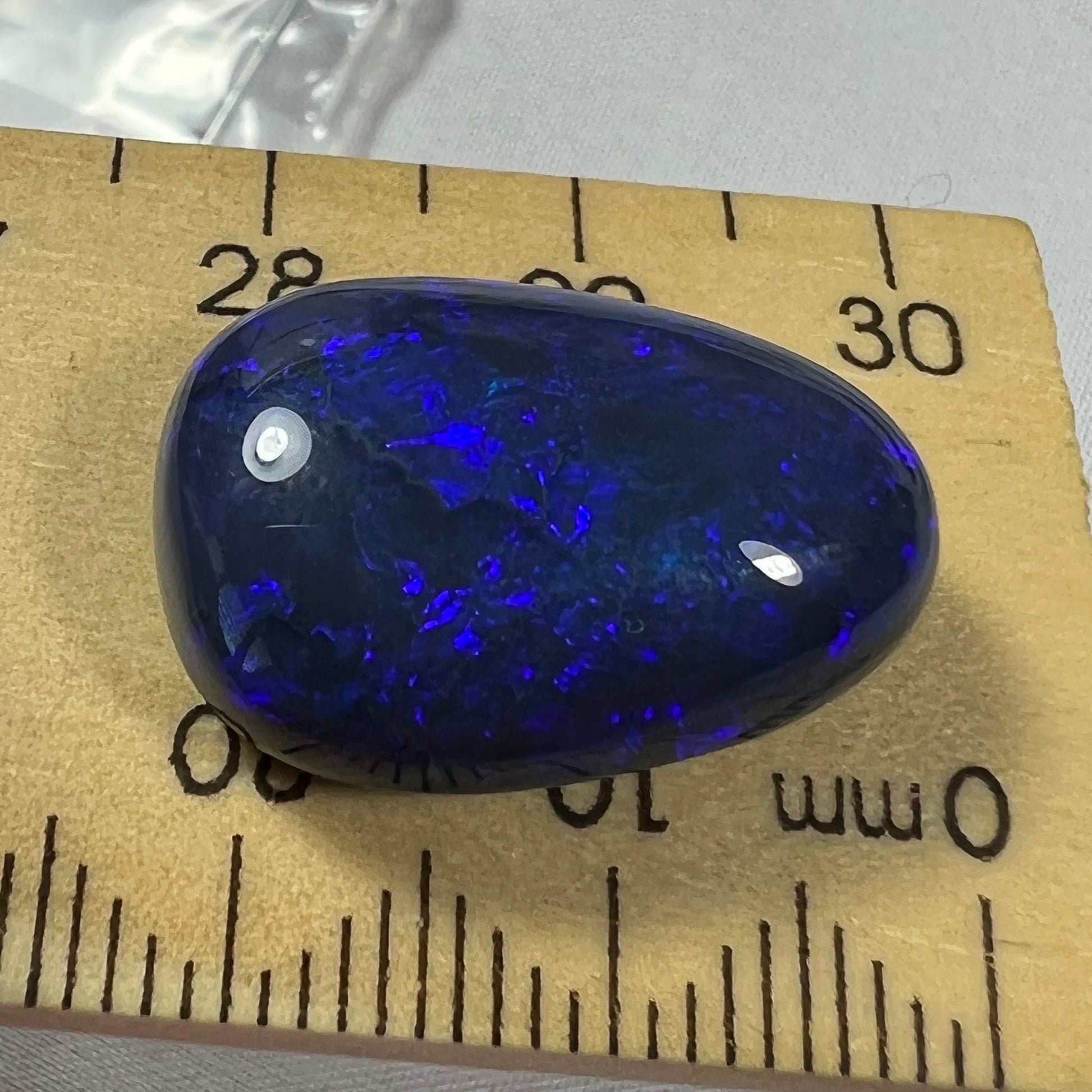 'Blue on black' solid black opal from Lightning Ridge. Perfect quality with awesome deep blue colour. This stone originated in the rough from the Tunnel Rats and was supplied to us from Phoenix Gems.