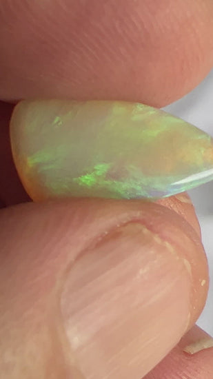 A great example of greens on grey. This Lightning Ridge solid Australian opal is polished to perfection.