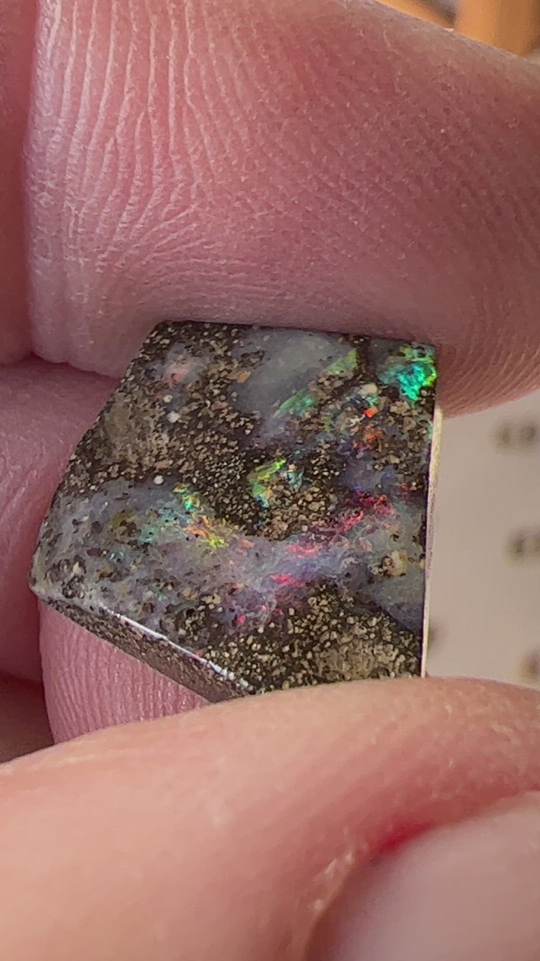 Nice play of colour in this lovely boulder opal, including vibrant reds.