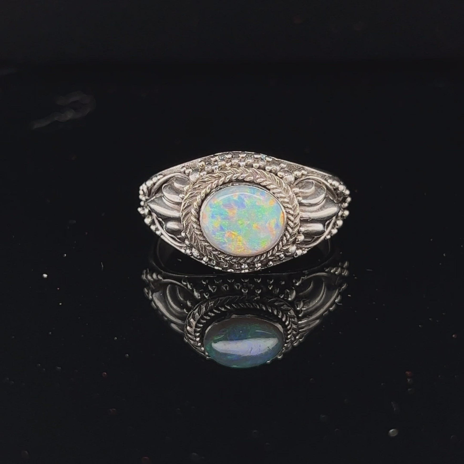 One of a kind perfectly formed silver ring with a beautiful Coober Pedy opal showing all the colours.