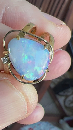 Fantastic one-off piece double ring with a beautiful 5ct Queensland Boulder opal showing reds, blues and greens, set off with a small diamond. Set in 14ct gold.