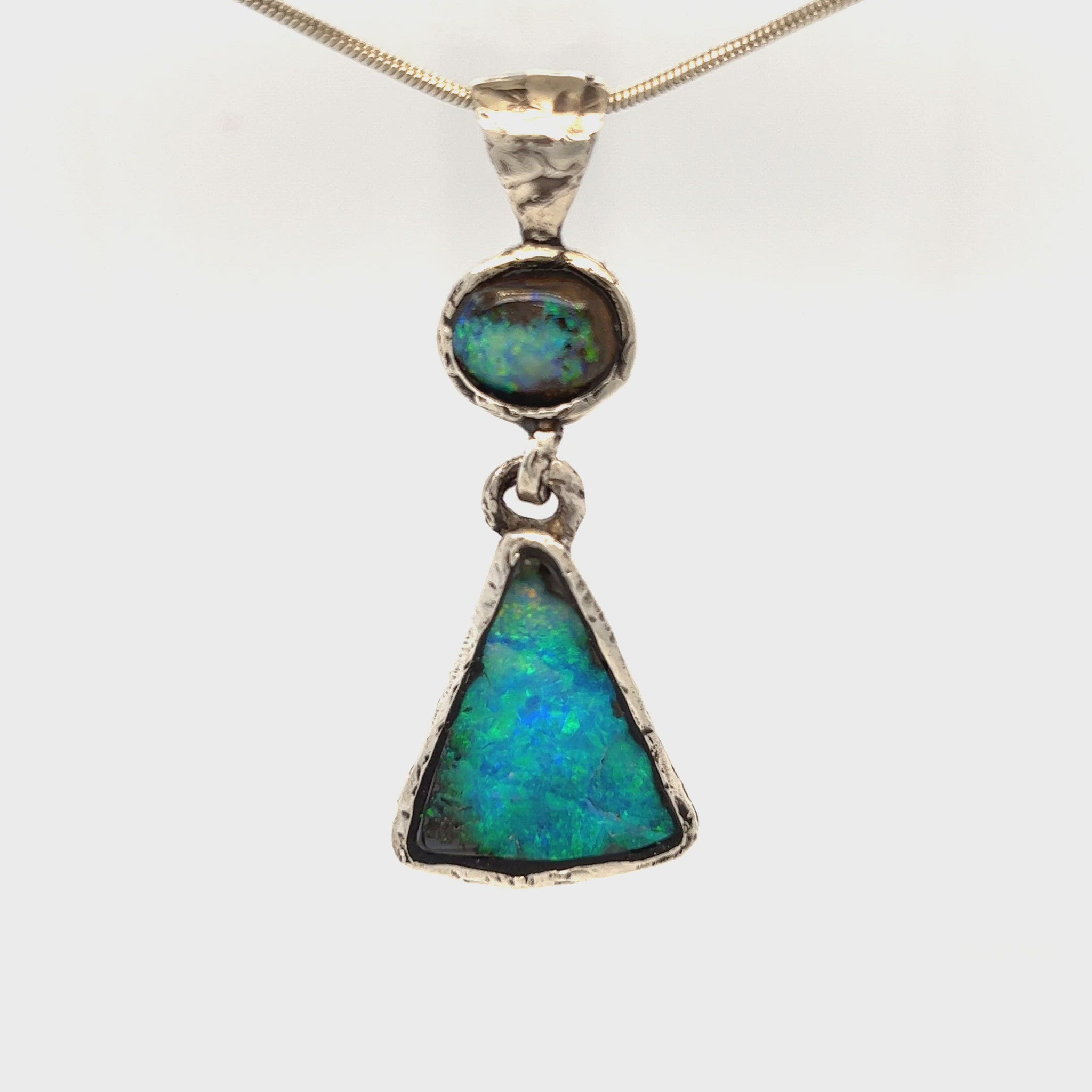Stunning one-off hand made solid Boulder opal pendant. Hinged between stones to allow movement. Highly textured to enhance rawness. Made with Argentium silver, which has a higher silver content using part recycled silver, and a lower allergenic. Crafted by Sally Fisher.