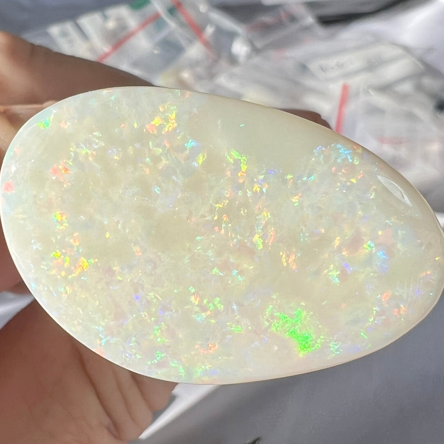 Large Coober Pedy solid white opal. Lots of colours and beautifully polished. Would make a great pendant. Double sided.