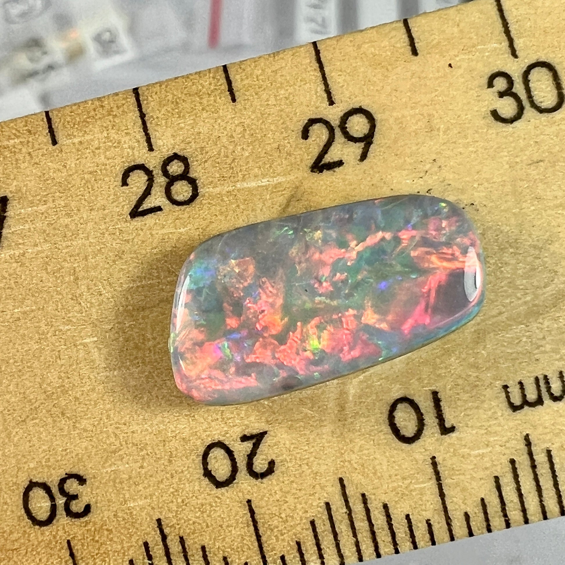 The colours in this opal are a knockout. Bright reds, blues, greens. A dark opal from Mintabie. Ready for setting.
