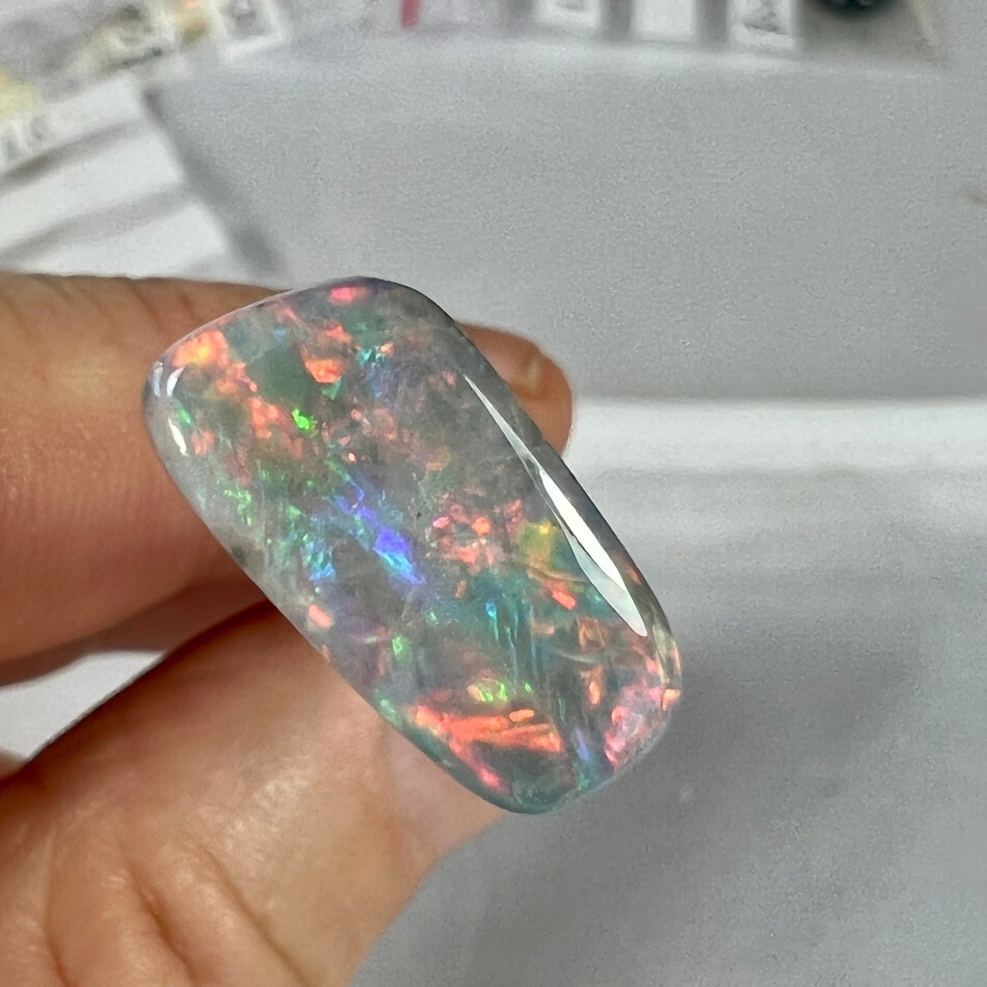 The colours in this opal are a knockout. Bright reds, blues, greens. A dark opal from Mintabie. Ready for setting.
