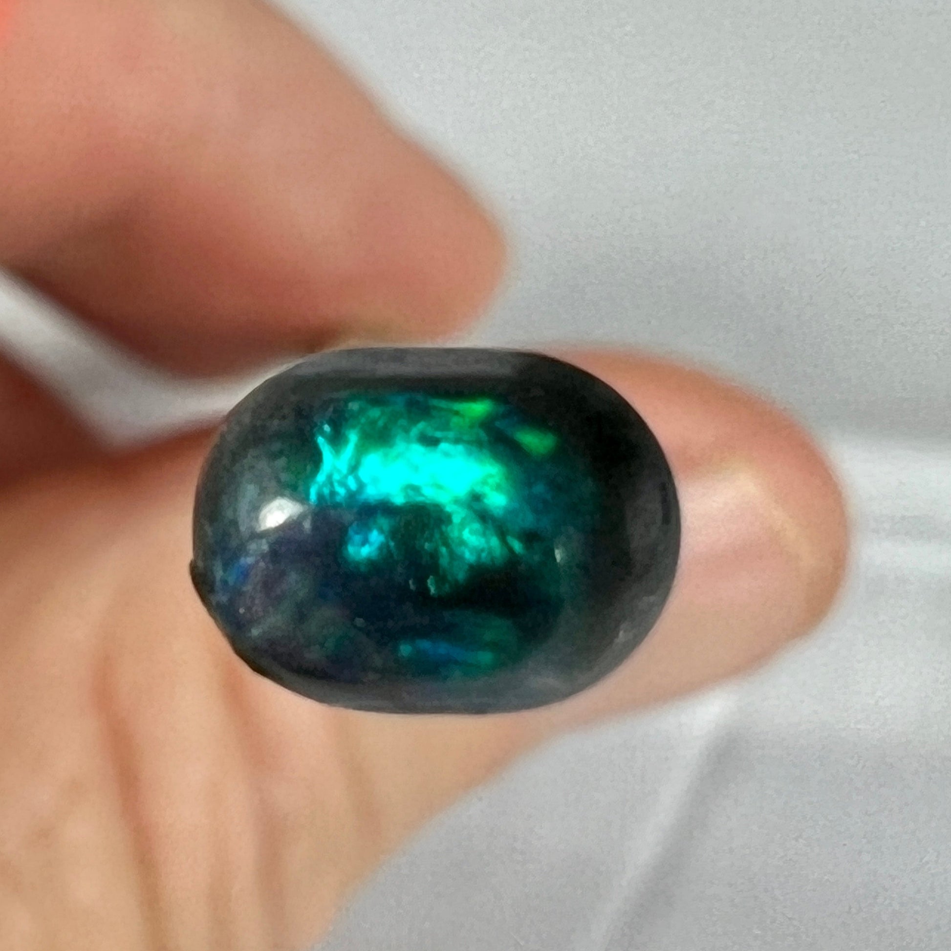 Nice little solid black opal from Lightning Ridge, displaying beautiful greens. Would make a great ring stone.