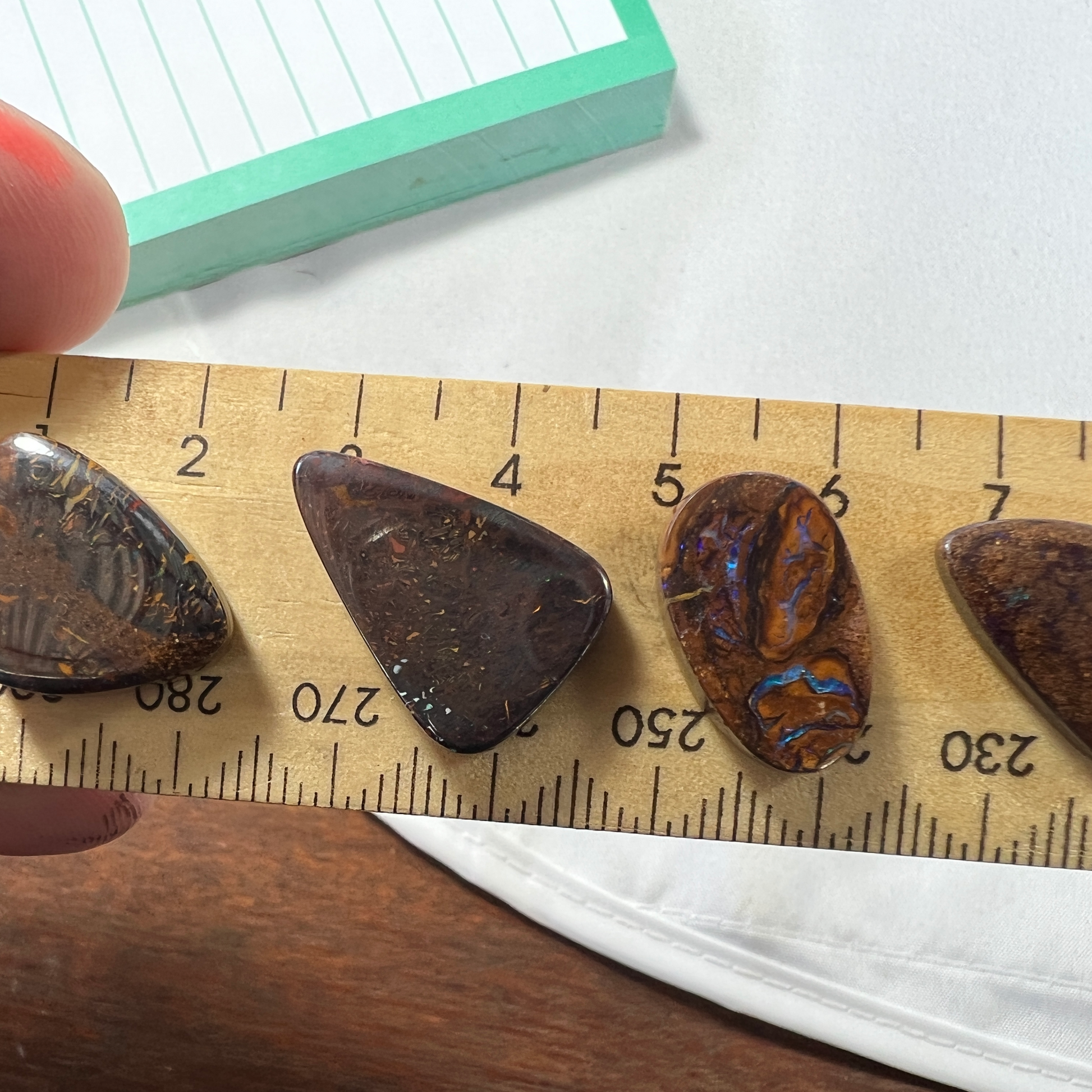 Four delightful pieces of boulder opal from Winton. Nice sparkles and polish.