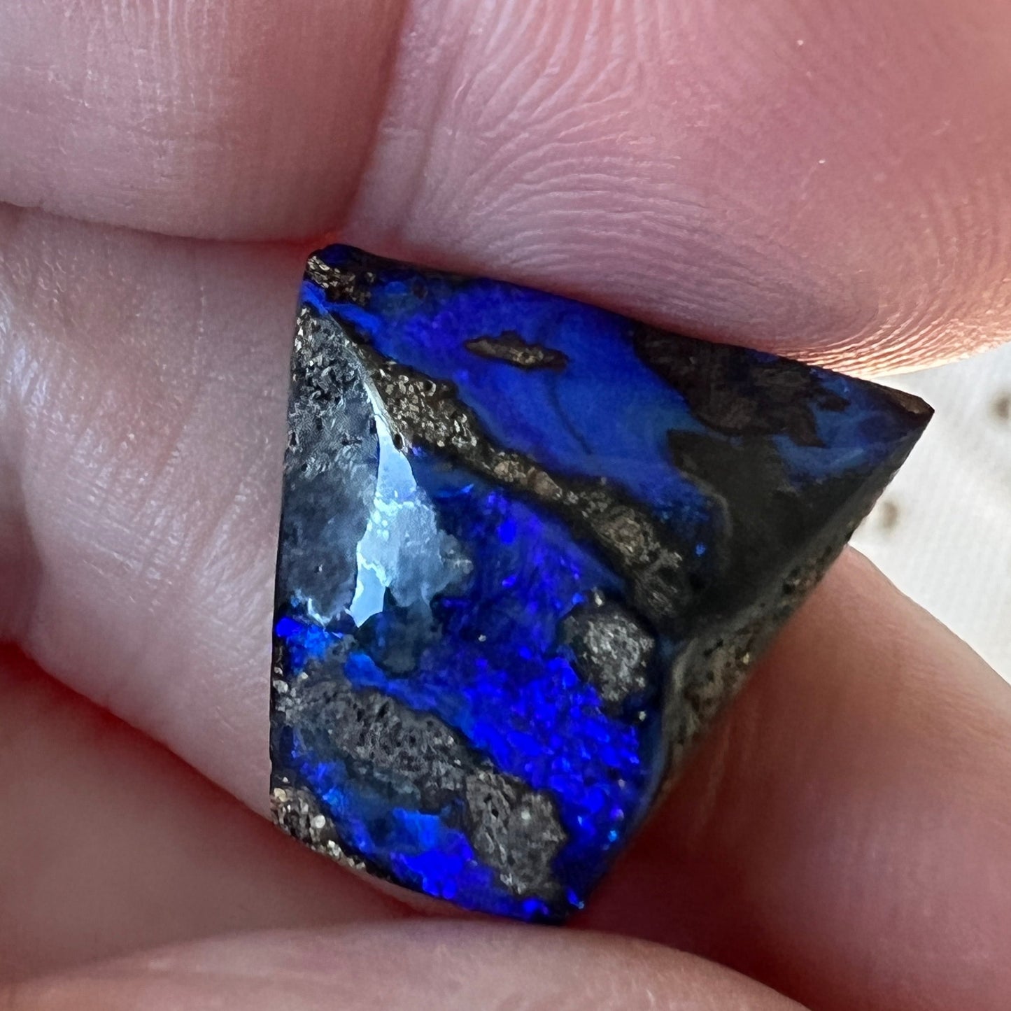 An unusual shaped piece of boulder opal with stunning blues throughout. 