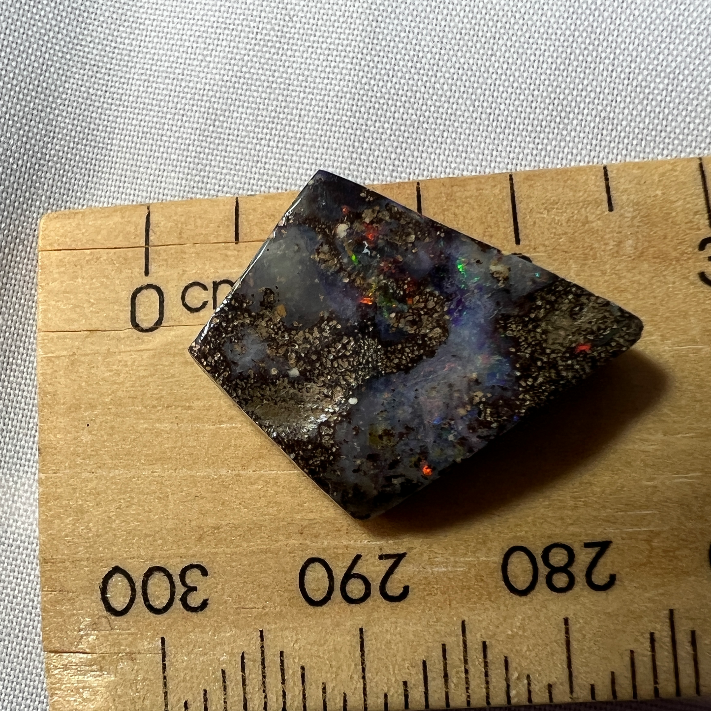 Nice play of colour in this lovely boulder opal, including vibrant reds.