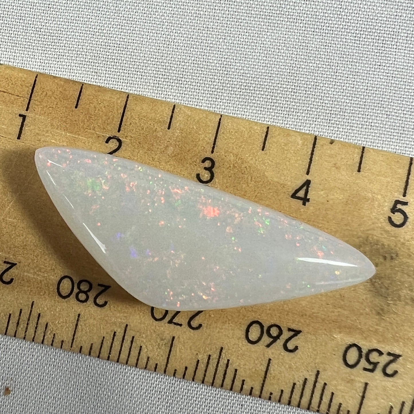 Nice piece of 19ct pin fire Coober Pedy opal, beautifully polished showing flashes of most colours. Polished by Bill Johnson.