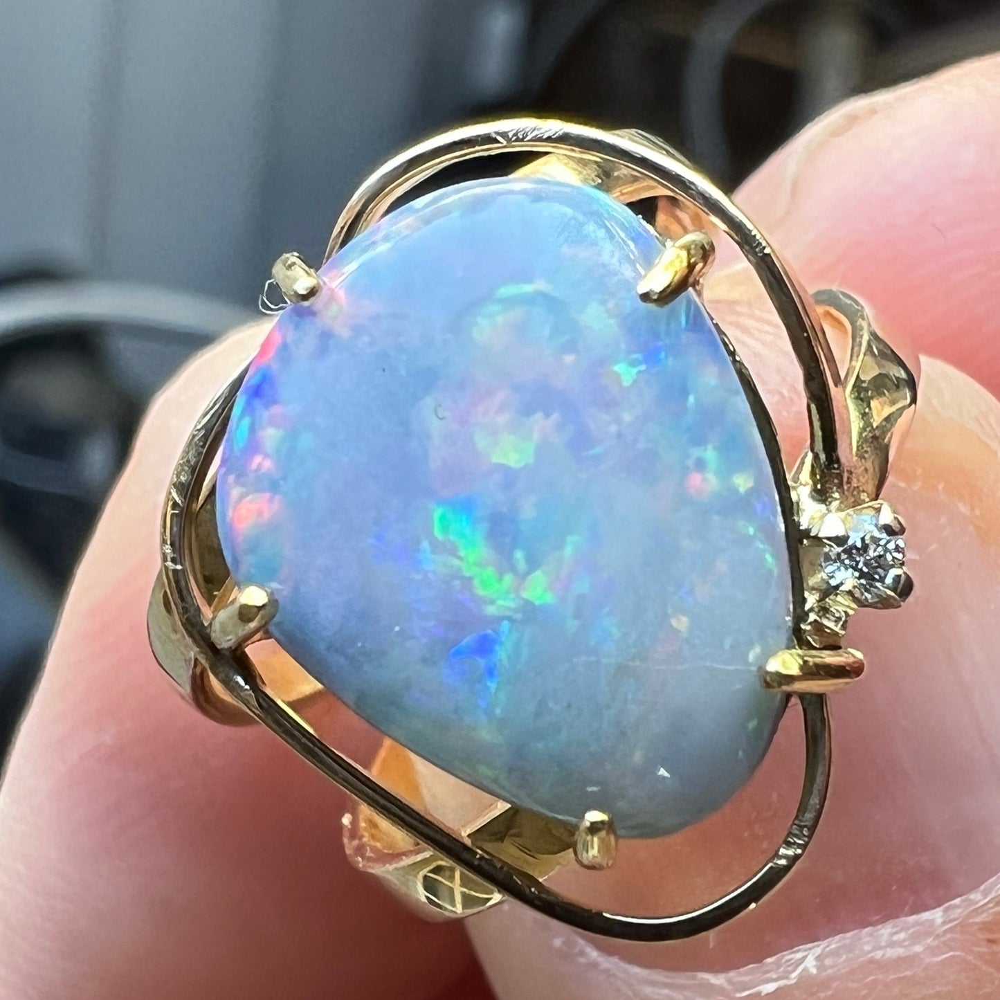 Fantastic one-off piece double ring with a beautiful 5ct Queensland Boulder opal showing reds, blues and greens, set off with a small diamond. Set in 14ct gold.